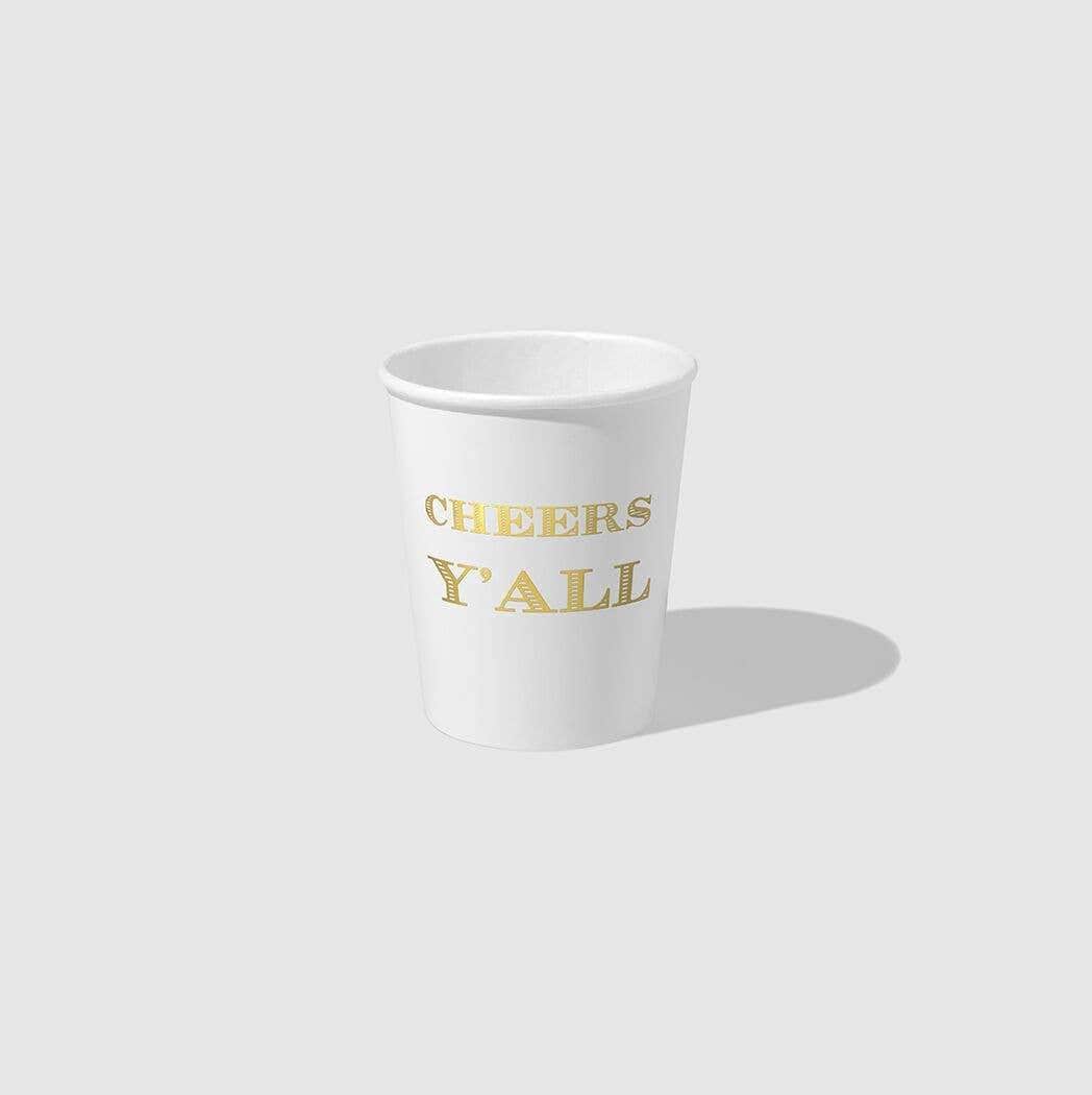 White paper cup with gold foil cheers y'all stamped on side