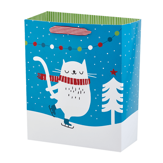 white cat in red scarf on ice skates and snow on blue bag with red and white ribbon handle