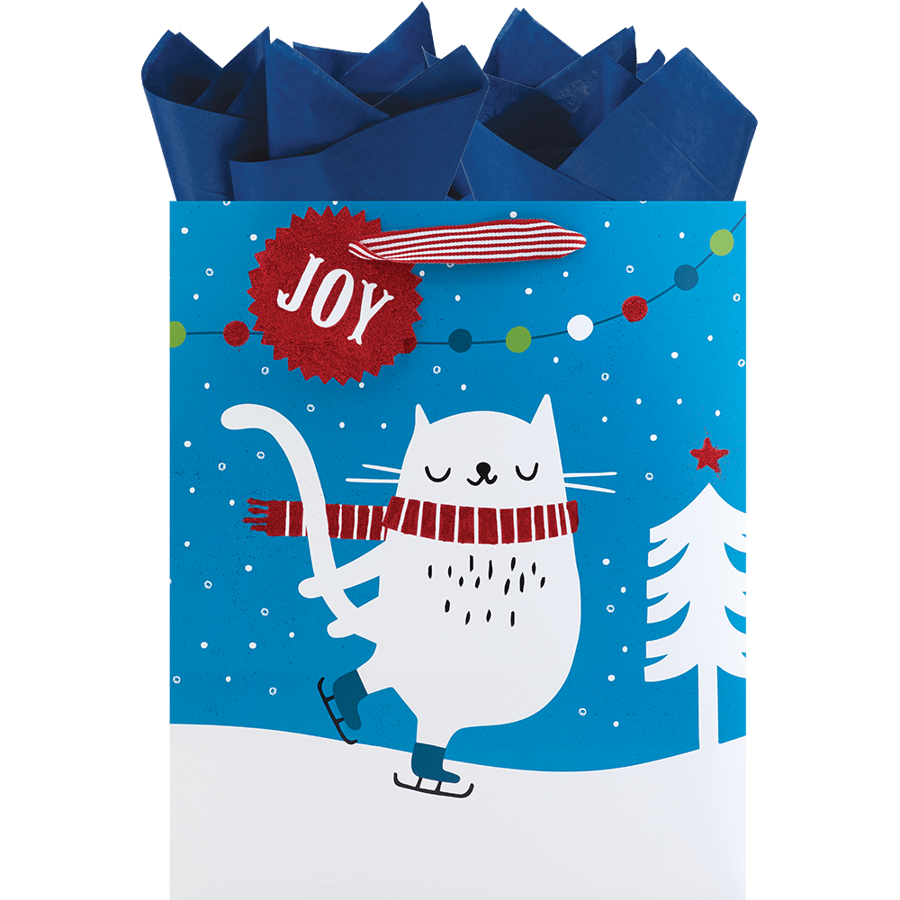 white cat in red scarf on ice skates and snow on blue bag with red and white ribbon handle